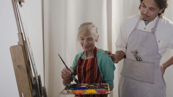 Teacher and woman painting