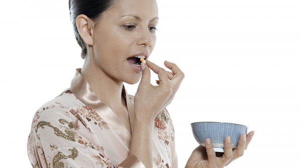 woman asian taking pill