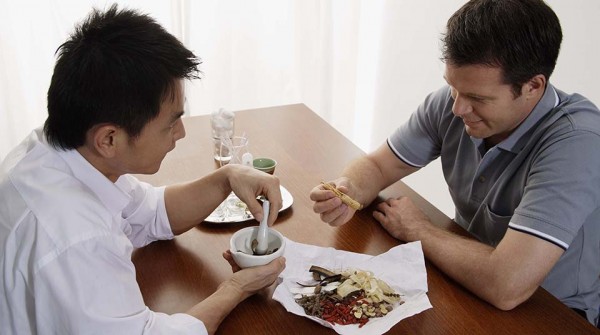 Chinese herbalist and patient